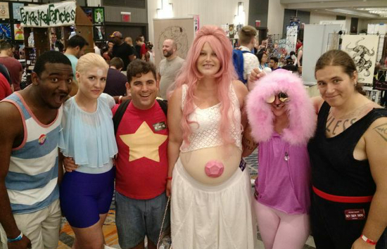Six cosplayers pose for a photo on the Flame Con convention floor.