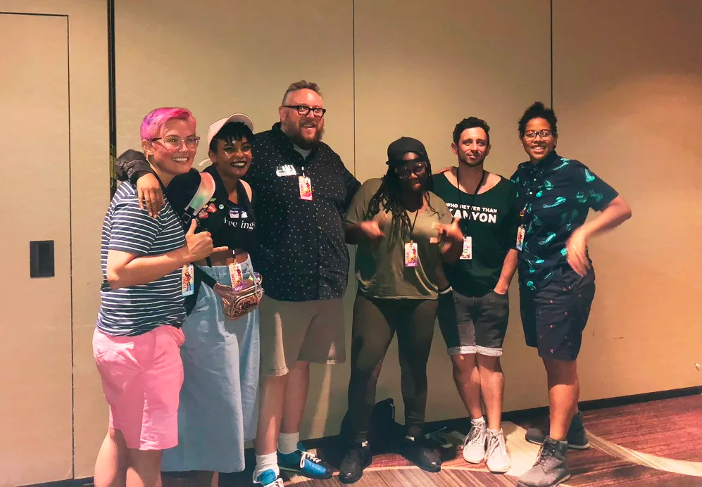 Group of 6 comics creators posing for a photo following a Flame Con panel.