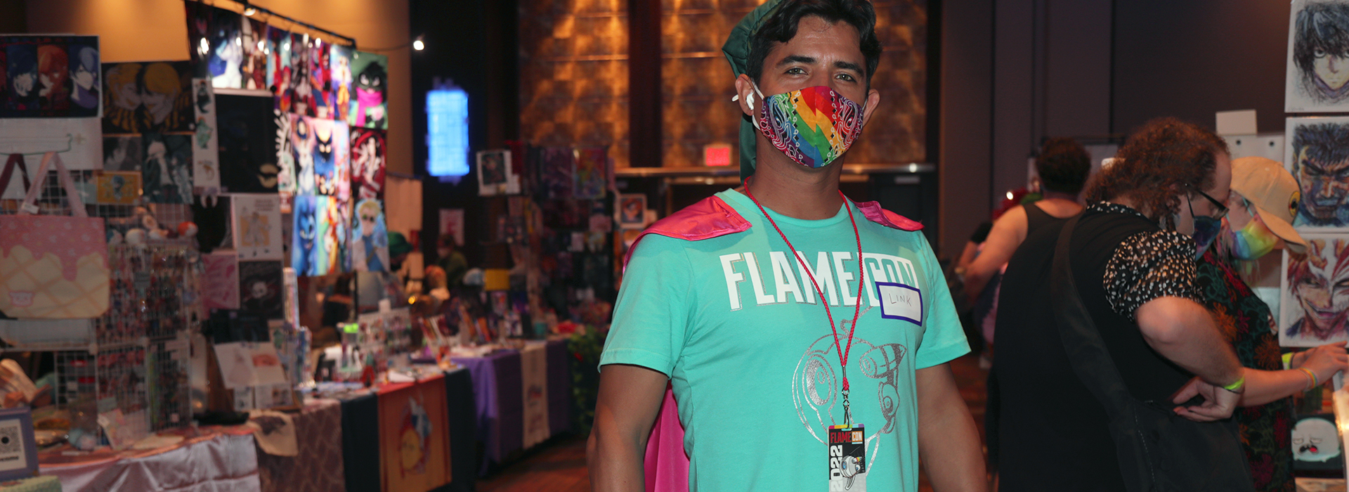 A Flame Con volunteer posing on the main convention floor.